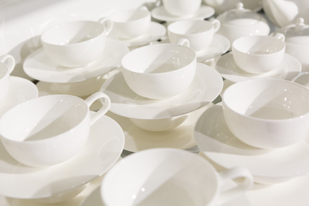 White ceramic coffee and tea cup in a cabinet.の写真素材