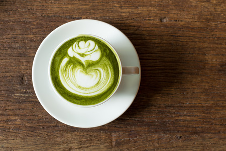Match Latte , Green Tea, on Wooden Background table.