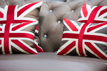 Vintage brown sofa with England flag pillows.の写真素材