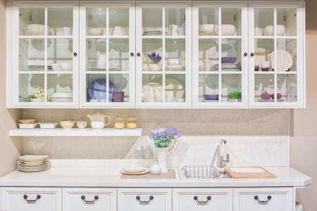 Interior of white domestic kitchen with full size cupboard on the wall.の写真素材