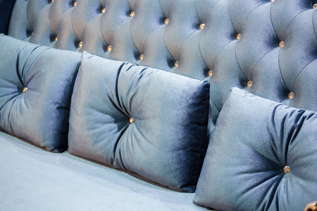 Close up of light blue  Velvet  backrest sofa with vintage style.with vintage style.の写真素材