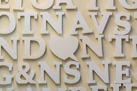 Wooden alphabet magnets stick on beige color wall.の写真素材