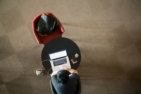 Young student study and working with laptop in side a library.の写真素材