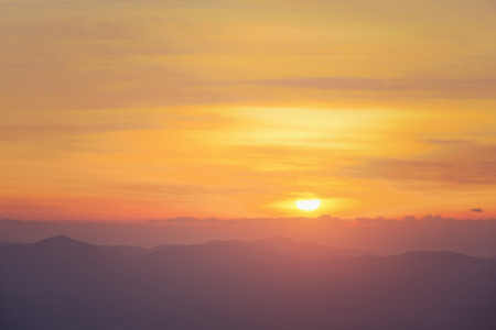 Beautiful morning with sunrise above mountain ranges at Doi Ang Khang national park, Thailandの写真素材