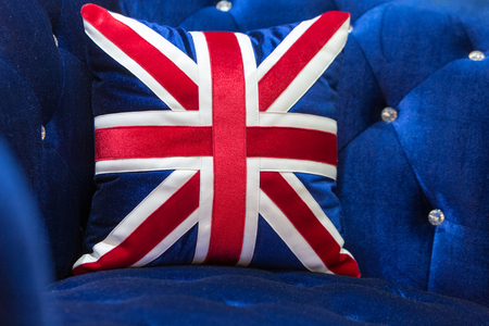 Vintage blue velvet sofa with England flag pillows.の写真素材