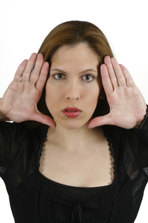 woman, framing her face with her handsの写真素材