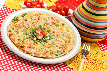 Spanish Tortilla with green peas and tomatoesの写真素材