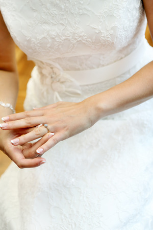 Young bride putting engagement ringの写真素材