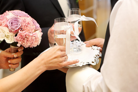 Young couple toasting with champagne at wedding receptionの写真素材