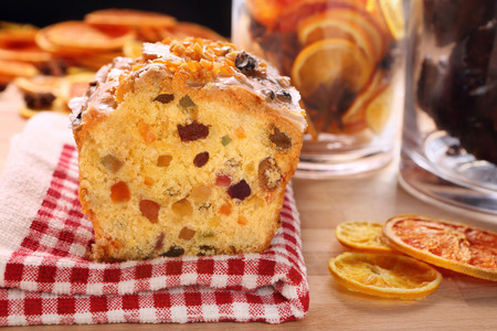 Christmas holly fruitcake on the tableの写真素材