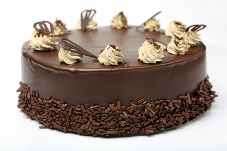 Cream chocolate cake with icing on white backgroundの写真素材