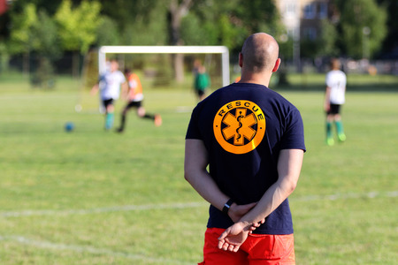 Medical rescuer for a football game of young boysの写真素材