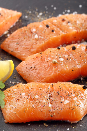 Fresh raw salmon fillet and aromatic spices for bakingの写真素材