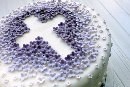 Cake for the first holy communion with cross on white background