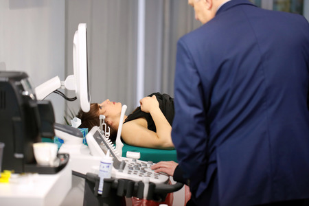 POZNAN, POLAND - APRIL 12. 2016: The doctor examines the patient by ultrasound. Poznan International Fair SALMED 2016, Poland.のeditorial素材