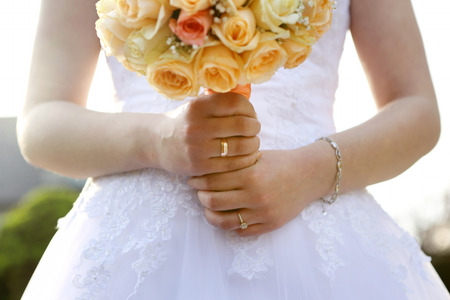 Bride with wedding rose bouquet outdoorsの写真素材