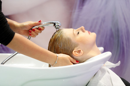 POZNAN, POLAND - MAY 07. 2016: Hairdresser washing client hair at The Look Beauty Vision Poznan 2016 on May 07 in Poznan, Poland.のeditorial素材