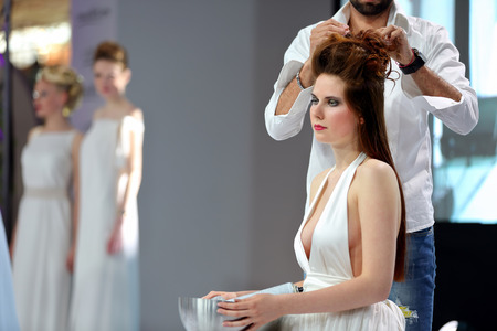 POZNAN, POLAND - MAY 07. 2016: Hairdresser arranging hairdo at The Look Beauty Vision Poznan 2016 on May 07 in Poznan, Poland.のeditorial素材