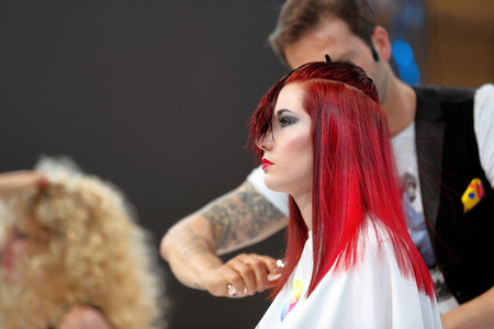 POZNAN, POLAND - MAY 07. 2016: Hairdresser arranging hairdo at The Look Beauty Vision Poznan 2016 on May 07 in Poznan, Poland.のeditorial素材