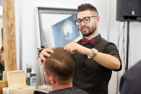 POZNAN, POLAND - MAY 07. 2016: Hairdresser making tramlines with razor at The Look Beauty Vision Poznan 2016 on May 07 in Poznan, Poland.のeditorial素材