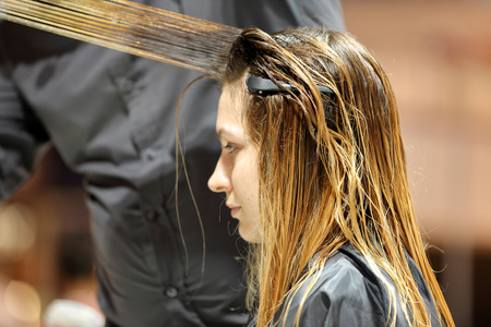 POZNAN, POLAND - MAY 07. 2016: Hairdresser trimming hair with scissors at The Look Beauty Vision Poznan 2016 on May 07 in Poznan, Poland.のeditorial素材