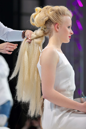 POZNAN, POLAND - MAY 07. 2016: Hairdresser arranging hairdo at The Look Beauty Vision Poznan 2016 on May 07 in Poznan, Poland.のeditorial素材