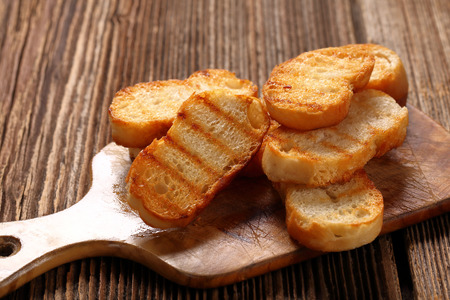 Grilled toasts on old wooden backgroundの写真素材