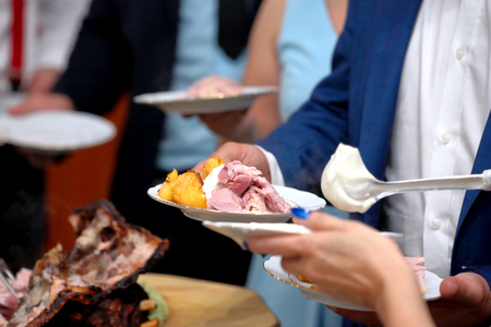 Waiter served roasted meat at the partyの写真素材