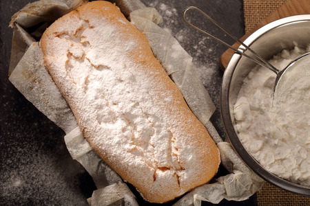 Homemade pound cake with powdered sugar in baking mold