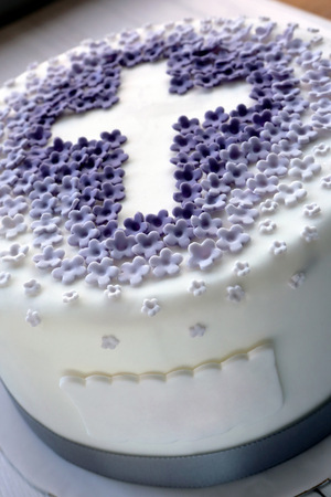 Cake for the first holy communion with cross and space for name textの写真素材