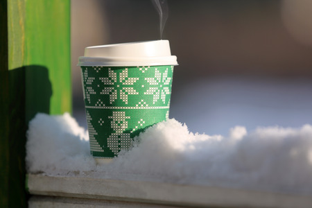 Hot cup of coffee in the winter scenery outdoor with space for text

の写真素材