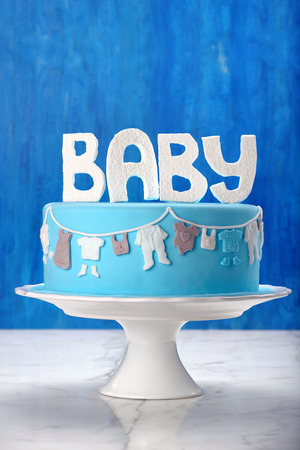 Newborn birthday blue cake on a stone background and blank space for textの写真素材
