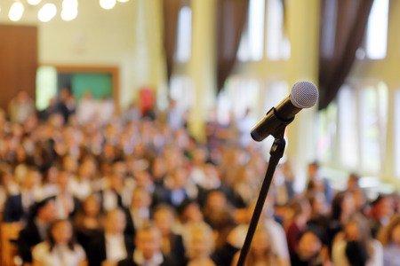 Blurred background of public event exhibition hall show concept with microphone