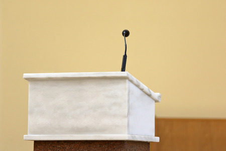 Rostrum with microphone in conference hall or church altar and empty space for textの写真素材