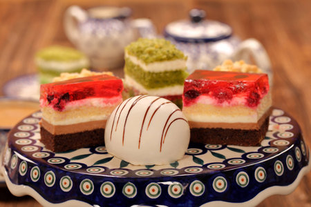 Afternoon coffee and cake with jelly and fruits on wooden backgroundの写真素材