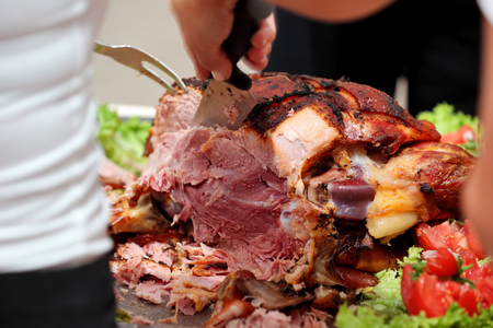 waiter serves roasted meat and baked potatoes at the party or wedding receptionの写真素材