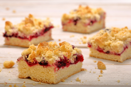 Cake with fruit and crumble on white wooden backgroundの写真素材