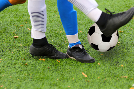 Boys playing a football match and empty space for text