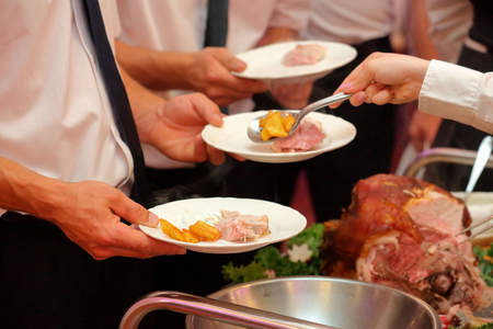 roasted meat and baked potatoes at the party or wedding receptionの写真素材