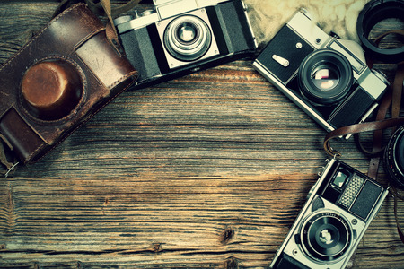 Vintage camera on wooden table and empty space for text or image for design workの写真素材