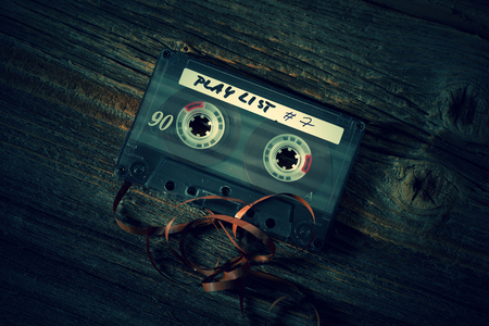 Old classic audio cassette with pulled out of tape with empty space for textの写真素材