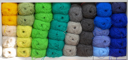 Colorful yarns for sewing on the shelf.  Skeins of yarn concept.