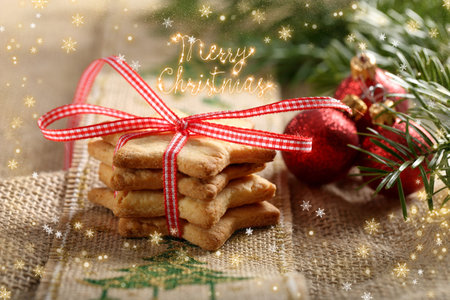 Christmas cookies with decorations on wooden background with merry christmas inscription.の写真素材