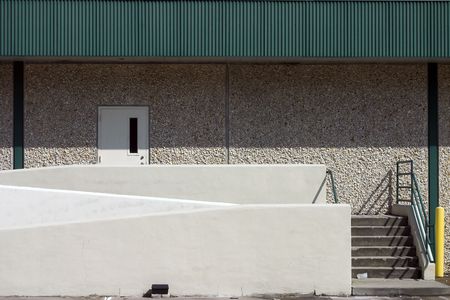 Warehouse door with staircase entry and ramp access