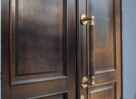 Wooden door with metal handle, close-up, front viewの写真素材