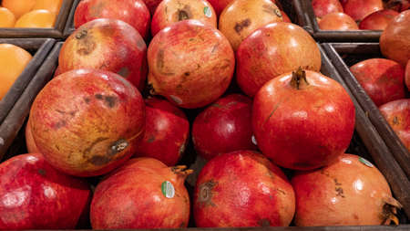 Fresh pomegranates on a market stall. Healthy food concept.の写真素材
