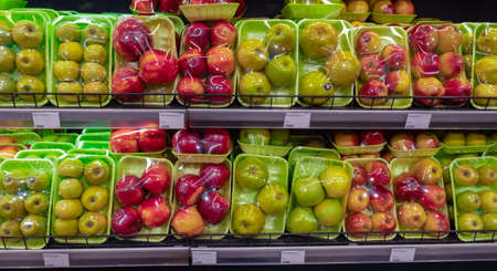 Variety of fruits in plastic boxes on shelf in supermarket, stock photoの写真素材