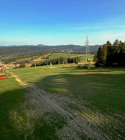 A view from the SÅotwiny Arena ski slope to the Beskid SÄdecki mountains, lots of forests and greeneryの写真素材