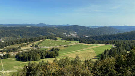 A view from the SÅotwiny Arena ski slope to the Beskid SÄdecki mountains, lots of forests and greeneryの写真素材