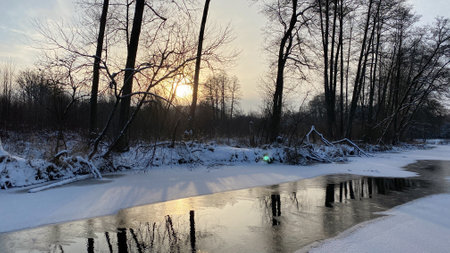 Winter country picture The river is partially frozen fields and forest near WÅ‚odawa covered with...